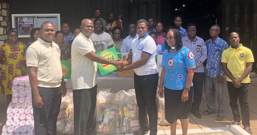 Dr Kwaku Ganu, Chairman of the anniversary planning committee, presenting the items to Mr Frank Ampeh.
