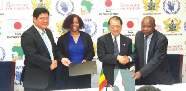 Mr Kwaku Agyemang Manu ( right), the Japanese Ambassoador, Mr Tsutomu Himeno (2nd right), Ms Rukia Yacoub and a representtive of the Ajinomoto company, exchanging the signed  documents
