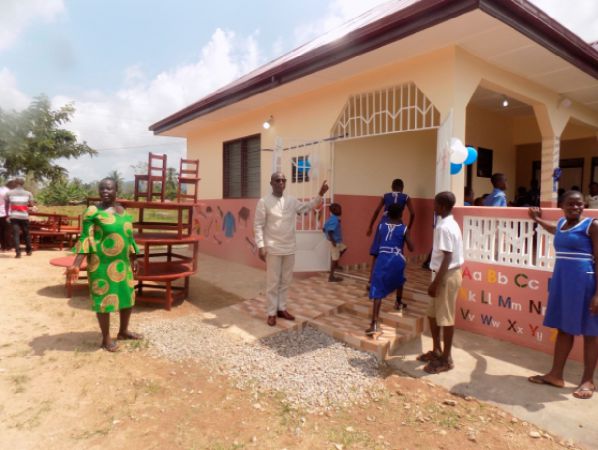 • Mr Seth Oduro-Boadu explaining a point to journalists in front of the new school block
