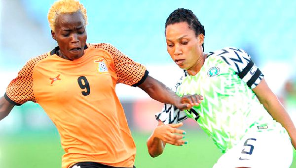 Nigeria Captain Onomi Ebe tries to put the brakes on Zambia forward Rachael Kundanji in yesterday’s match