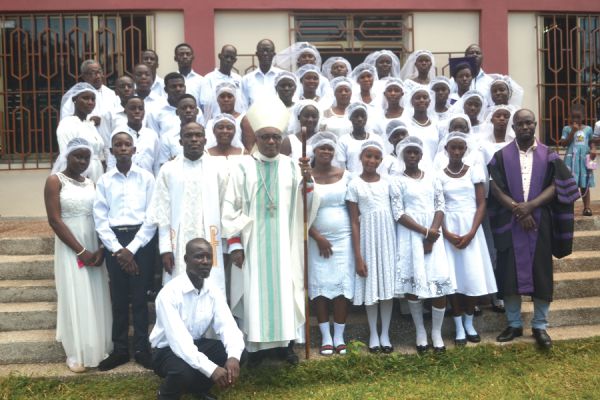 • Rt Rev. Dr Victor Reginald Atta-Baffoe (arrowed), with Rev. Father Moses Aaron Eduah (3rd left, front row), the Parish Priest, some members of the clergy and the newly confirmants 