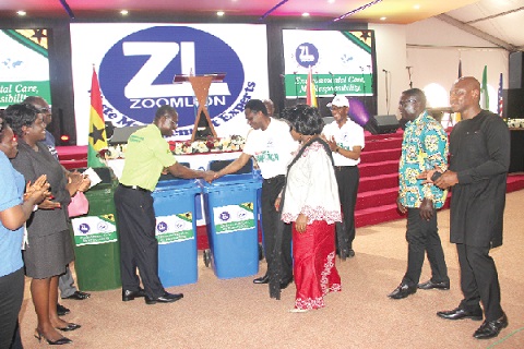 Dr Joseph Siaw Agyepong (3rd left), Chief Executive Officer of Zoomlion, presenting some of the waste bins to Apostle Eric Nyamekye (5th right), Chairman, the Church of Pentecost, during the ceremony. With them are Madam Cecilia Dapaah (4th right), the Minister of Sanitation and Water Resources, other dignitaries and officials of Ecobank. Picture: EDNA ADU-SERWAA
