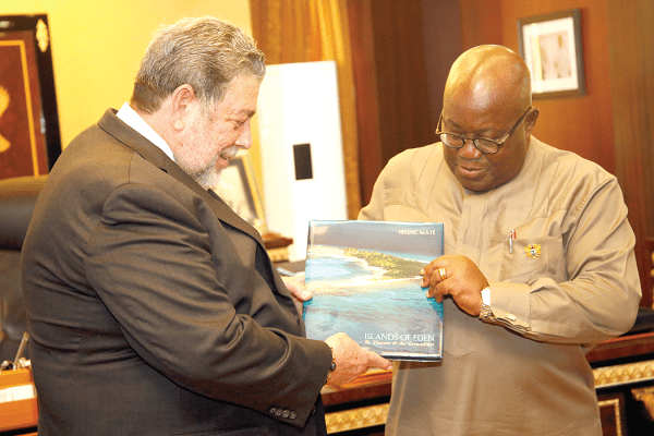  Dr Ralph Gonsalves (left), the Prime Minister of St. Vincent and the Grenadines, presenting a book to President Akufo-Addo at the Jubilee House in Accra.