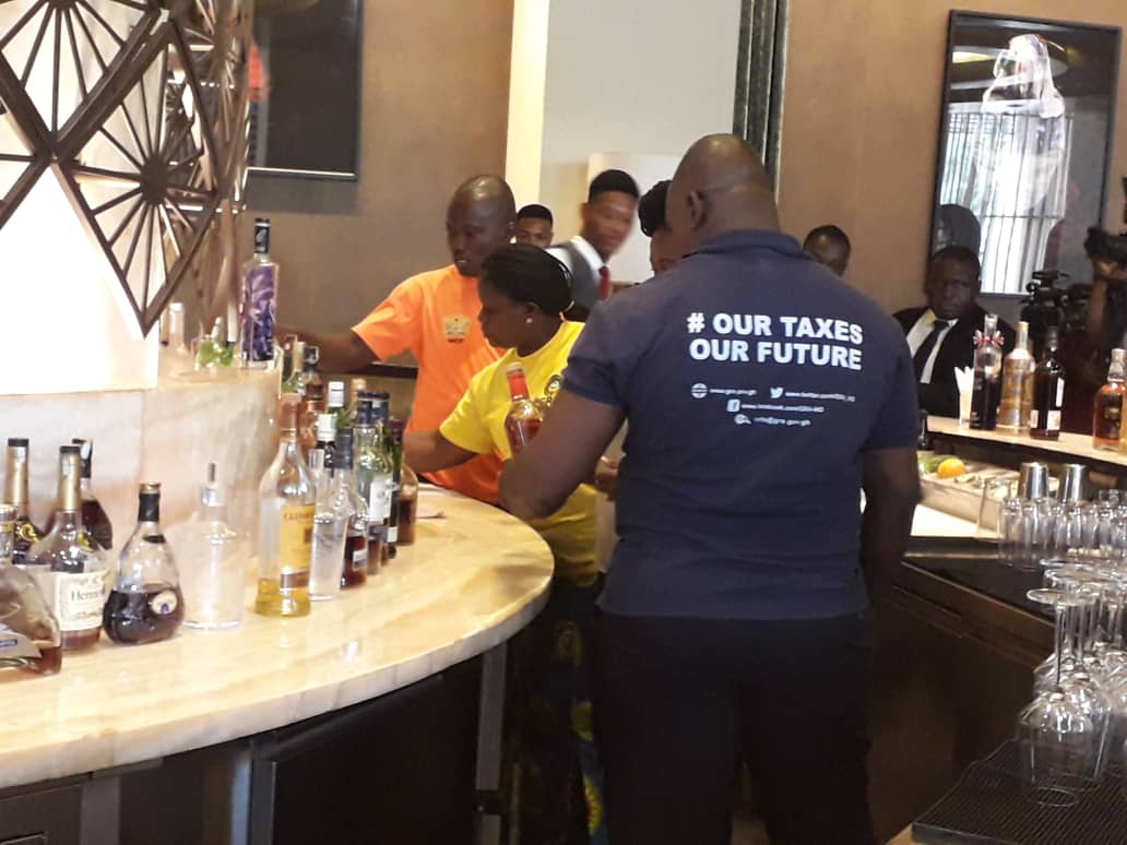 GRA officials inspecting bottles at the bar of Kempinski Gold Coast