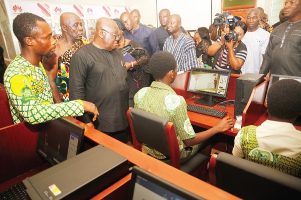 President Akufo-Addo observing a display of ICT skills by some students after the inauguration of the J.B. Danquah Centre. 
