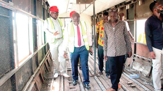 Mr Osei Kyei-Mensah-Bonsu (2nd left) inspecting some old coaches that are yet to be refurbished. On his left is Nana Osei Bonsu, the Regional Chairman of Garages, Magazine-Kumasi.