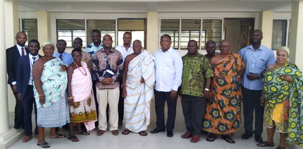 The National Health Insurance Authority (NHIA) team in a group photograph with members of the Oguaa Traditional  Council