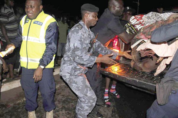  The Adenta police placing the corpse into a pick-up vehicle