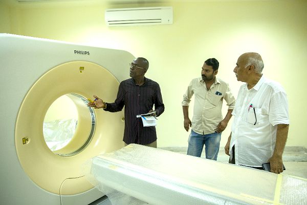  Mr Emmanuel Modey (left), Daily Graphic Reporter, making enquiries about the newly fitted MRI equipment from Mr Sherif Mahmoud (right), Bio-Medical Engineering Director of Euroget-De Invest, during a tour of the facility. With them is Mr Abhilash Sadanadan, also an engineer
