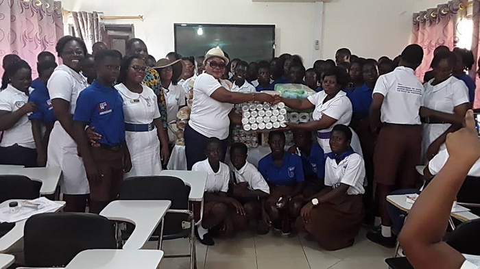 The Headmistress of Perry Hayford Memorial JHS, Ms Grace Anane presenting the items to Ms Hannah Cromwell, a Deputy Director of Nursing, Takoradi Hospital.