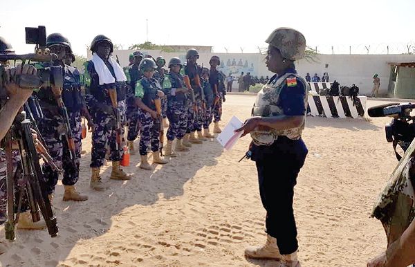 Inspector Peace Abra Nyampo (right), Joint Operations Co-ordinator of the AMISOM, addressing a parade of police personnel before dispatching them to their various duty points