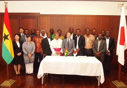 Mr Tsutomu Himeno, (6th left), the Japanese Ambassador to Ghana, with representatives of the beneficiary organisations after signing the agreement