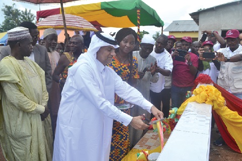 Mr Mohammed Ahmed Alhumaidee cutting the tape to inaugurate the Agona Nkranfo borehole while Mrs Justina Marigold Assan looks on