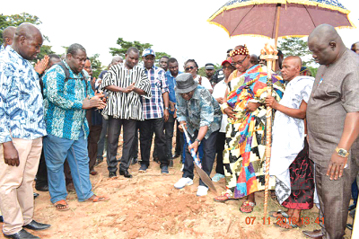 The Minister for Food and Agriculture, Dr Owusu Afriyie Akoto performing the sod cutting ceremony while Nana Osabarima Antwi Adjei V, the Twifohene of the Buem Traditional Area and chief of Okadjakrom and other dignitaries applaud