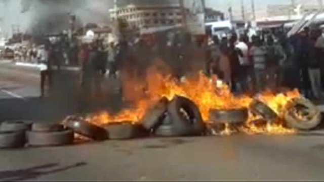 Residents of Adentan set fire to several disused car tyres to block the road in protest against frequent car knock downs 