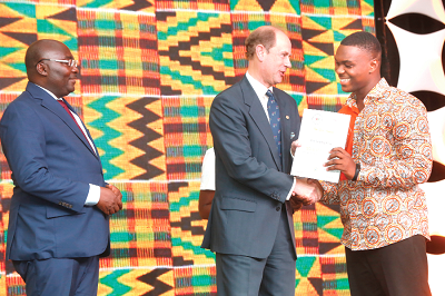 Prince Edward, Earl of Wessex presenting a Gold award to Master Yaw Biney Gyapong (right), one of the recipients of the award. Looking on is Dr Mahamudu Bawumia (left). Picture by SAMUEL TEI ADANO