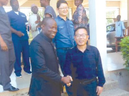  Mr Salifu Saeed (left) exchanging pleasantries with Mr Yin Jianhua after signing the MoU