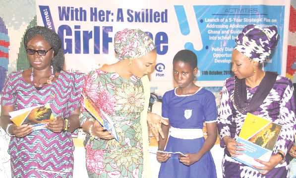 Mrs Samira Bawumia (2nd left) explaining the five-year strategic plan to Miss Deborah Ampah (2nd right), a student of the All Saints Anglican Model School, at the launch. Those with them are Ms Gifty Twum-Ampofo (left) and Dr Afisah Zakariah (right).