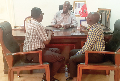 Mr Danny Anang (middle) speaking to Mr Kobby Asmah (left) and Mr Victor Kwawukume of the Daily Graphic