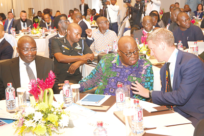 • President Nana Addo Dankwa Akufo-Addo (2nd right) interacting with Mr Iain Walker (right), the British High Commissioner in Accra, at the Ghana-UK Investment Summit. With them is Vice-President Dr Mahamudu Bawumia (left). Picture: Samuel Tei Adano