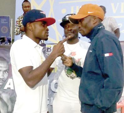 Emmanuel ‘Gameboy’ Tagoe (left) came face to face with his opponent Paulus Moses at yesterday’s press briefing
