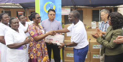 Mr Stephen Nana Amoako Wiredu (2nd right), Deputy Chief Executive Officer of Friends of Mental Health presenting the items to Dr Ama Boadu (2nd left), Head of Public Relations, Accra Psychiatric Hospital during the ceremony. Looking on are Mr Tang Hong (3rd left), Chairman of the Ghana Chinese Chamber of Commerce, some members of the  Chamber and officials of the Accra Psychiatric Hospital.