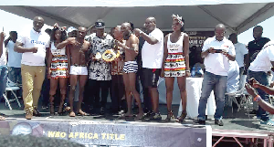 Fight promoter Asamoah Gyan (with title belt) flankd by Emmanuel ‘Gameboy’ Tagoe and Moses Paulus at yesterday’s weigh-in