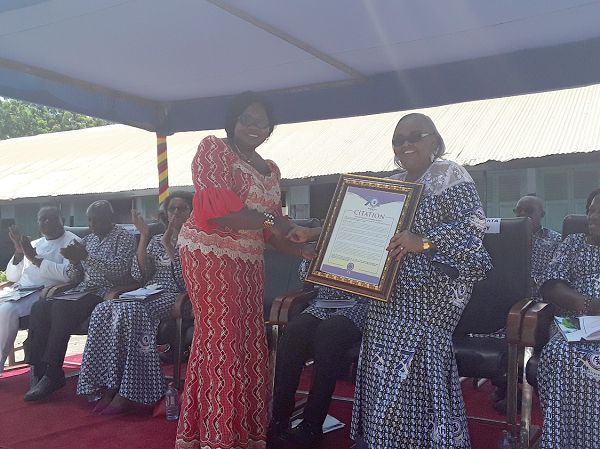  Mrs Catherine Appiah -Pinkrah (left), Director of Pre-Tertiary Education at the Ministry of Education, presenting a citation to Mrs Theodora Alberta Quartey.