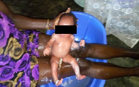 The baby being washed off after its retrieval
