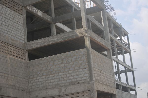  The uncompleted storey building from which the victims jumped. INSET: One of the victims on admission at the Legon Hospital Pictures: EBOW HANSON