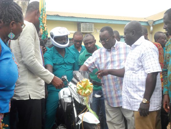  Dr Owusu Afriyie Akoto (second right) symbolically starting the engine of one of the motorbikes after they had been presented for distribution to extension officers in the region. INSET: The 100 motorbikes