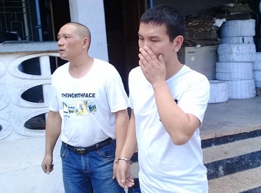 The suspects, Chen Yanshan (left) and Lunyou Subeing, after their arrest
