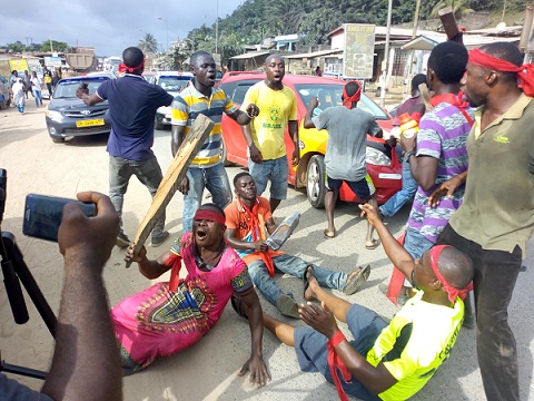 A group demonstrating over bad roads at Tarkwa in the central region.