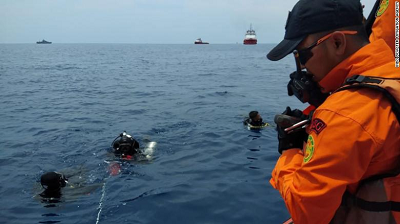 Search and rescue teams conduct dives at the crash site.