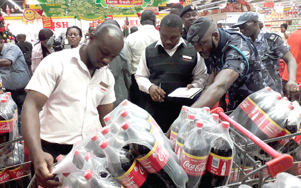 Some officials of the GRA Customs Division checking products at the Achimota Retail Centre in Accra 