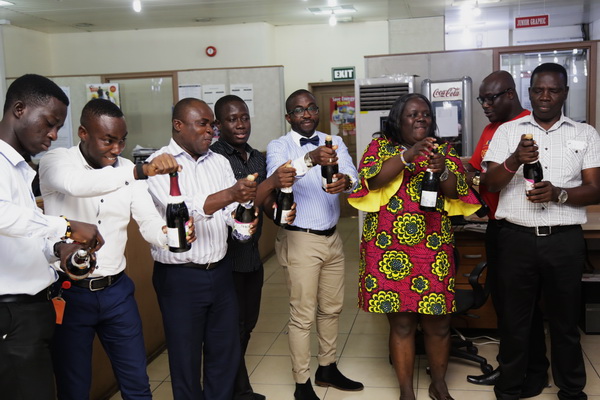 Some members of staff of the company popping champagne  to mark the anniversary. Pictures: EMMANUEL ASAMOAH ADDAI