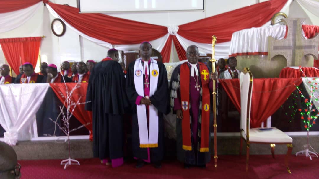 Rev Dr Asare Kusi (midle) inducted as Koforidua Methodist Bishop. Standing with him holding the staff is Most Rev Dr Paul Boafo, Presiding Bishop of Methodist Church Ghana