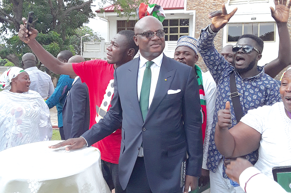 Mr Kojo Bonsu surrounded by his supporters after addressing the press conference. Picture: VICTOR KWAWUKUME