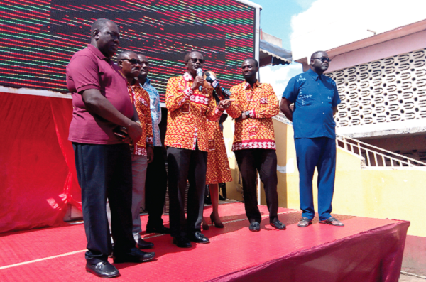 • Dr Papa Kwesi Ndoum (with microphone), addressing traders at the spare parts retail market at Abosey Okai