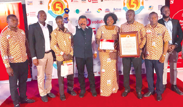 • The Managing Director, Nyonkopa Cocoa Buying Company Limited, Dr Joshy Varkey (fourth left), and workers with the SMEGA Award and citations after the event