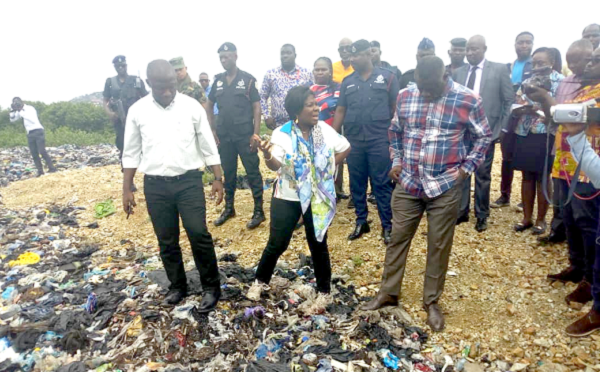  Mrs Cecilia Abena Dapaah (arrowed) making a point at a refuse dump at the Mallam Market that is being reclaimed. With her is the Chief Executive of the AMA, Mr Mohammed Nii Adjei Sowah (left)