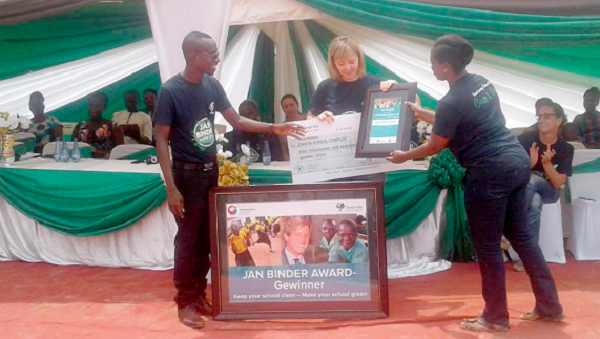  Ms Auke Luckja (middle) presenting a dummy cheque and citation to Mr David Nyame Tawiah, proprietor of Davita School Complex
