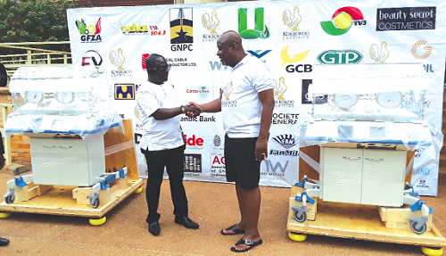 Mr Kwame Sefa-Kayi (right) presenting the incubators to Dr Kofi Amponsah