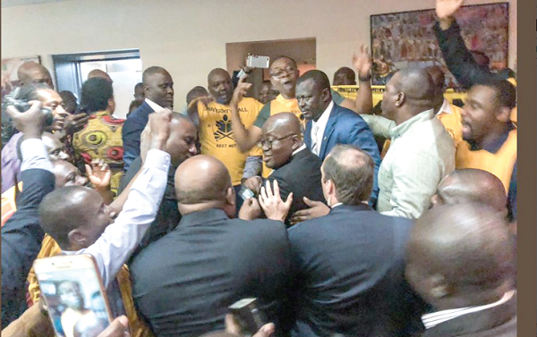 Some members of the KNUST Katanga Hall Alumni in the US  singing and escorting President Akufo-Addo out of  the meeting hall after his interaction with the Ghanaian community