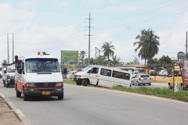 A "trotro" driver making an illegal U-turn onto a busy highway at Ankwa-Doboro