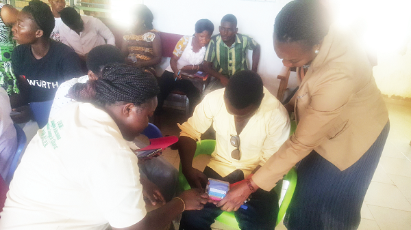 Ms Estella Abazesi, District Director Health, Talensi-Tonga assisting some of the volunteers during the training