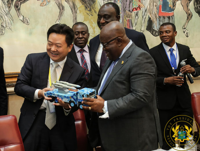 Mr Zhang Yuzong presenting a miniature version of one of the trucks to be manufactured in Ghana to President Akufo-Addo