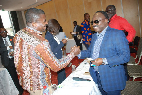 Mr Agyenim Boateng Adjei (right), the CEO of the Public Procurement Authority, exchanging pleasantries with Mr Kwadwo Fordjour of Adom FM after the meeting with the media personnel