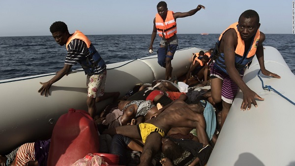 Migrants step over dead bodies while being rescued in the Mediterranean Sea, off the coast (GOOGLE.COM).