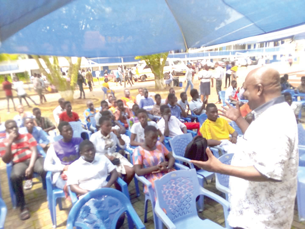 Mr Samuel Kwame Agyekum (right) the District Chief Executive (DCE) for Asuogyaman, advising both parents and students of the Anum–Bosso Senior High School                 